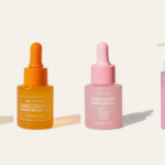 Four pheromone perfume and oil bottles from the EROSSA range on a cream background